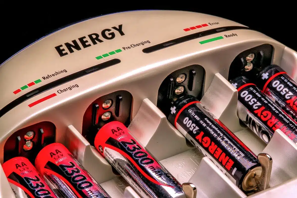 Batterie domestique installée à côté d'une borne de recharge dans un garage lumineux