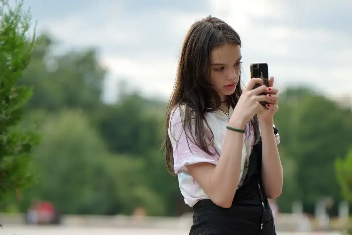 Jeunes utilisateurs regardant un smartphone pliable en plein jour
